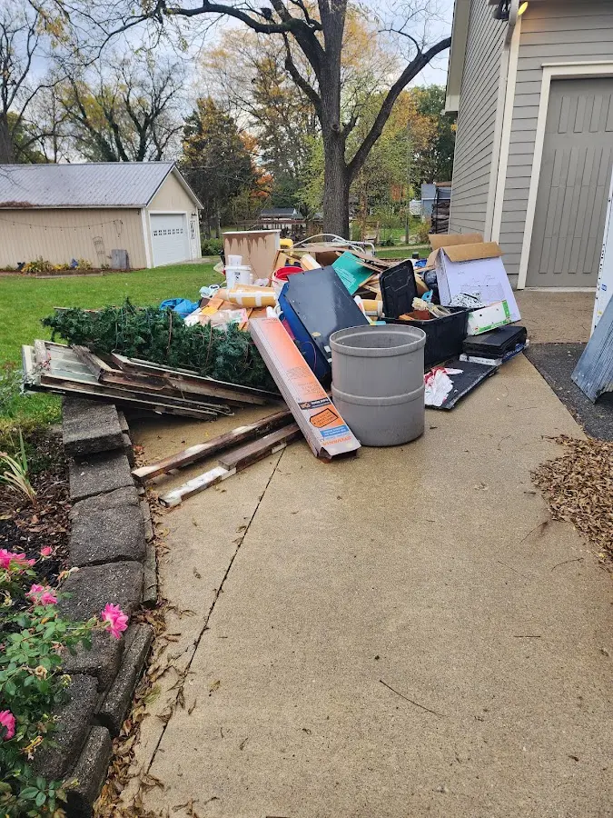 Dumpster being loaded with debris for 30 Yard Dumpster Rental in Gallipolis